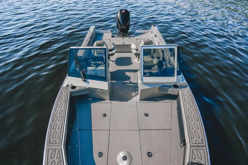 Slide: The Image of 2026 KingFisher 2125 Arrow Sport boat on water, showcasing spacious deck and seating. - 8