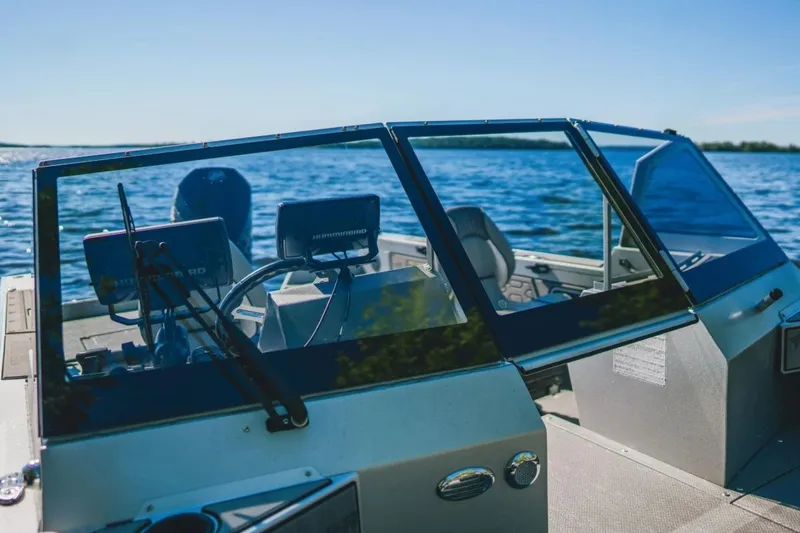 Slide: The Image of 2026 KingFisher 2125 Arrow Sport boat on a sunny lake, featuring modern navigation equipment. - 9