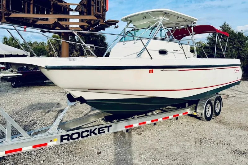 The Image of 2002 Boston Whaler 290 Outrage boat on a trailer, ready for transport. - 1