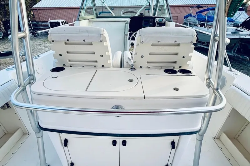Slide: The Image of 2002 Boston Whaler 290 Outrage boat interior with seating and control panel. - 23