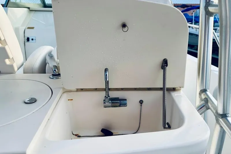 Slide: The Image of Boston Whaler 290 Outrage 2002 boat sink with faucet and storage compartment. - 24