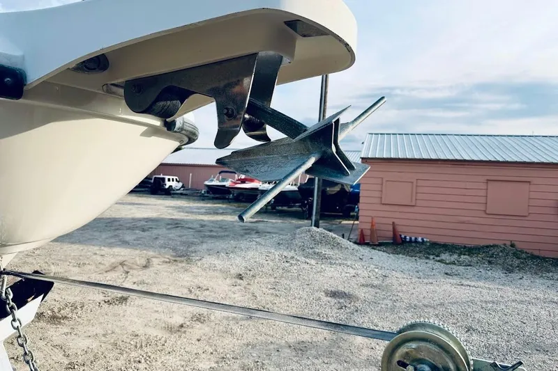 Slide: The Image of Bow anchor of a 2002 Boston Whaler 290 Outrage, parked on gravel. - 3