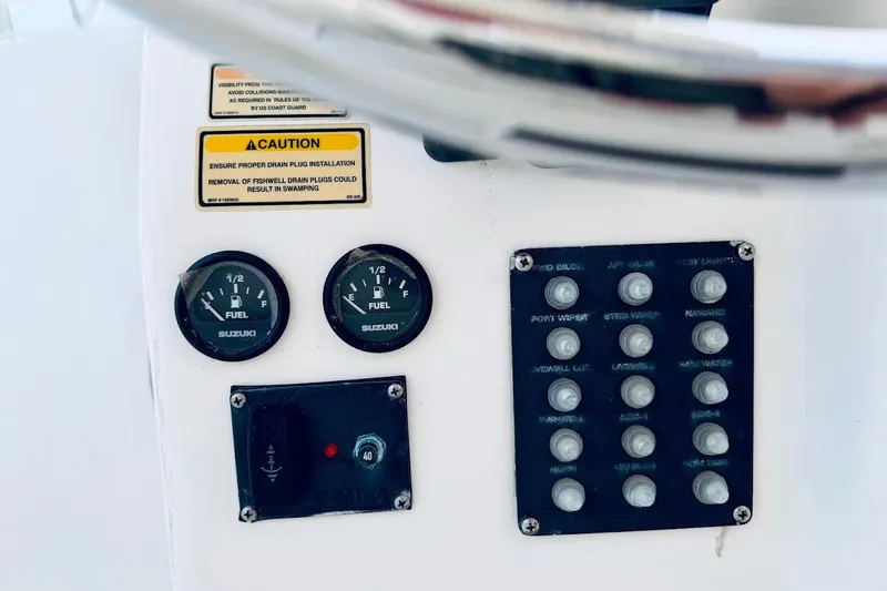 Slide: The Image of Control panel of a 2002 Boston Whaler 290 Outrage boat with gauges and switches. - 31