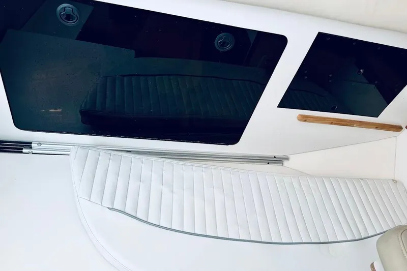 Slide: The Image of Interior view of a 2002 Boston Whaler 290 Outrage boat, featuring seating and storage compartments. - 42