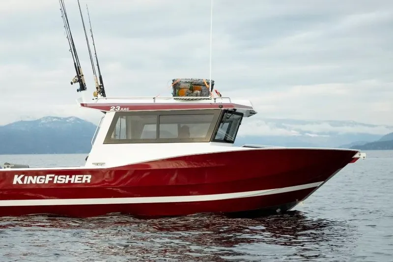 The Image of 2026 KingFisher 23 XAC boat on water, featuring a sleek red and white design. - 1