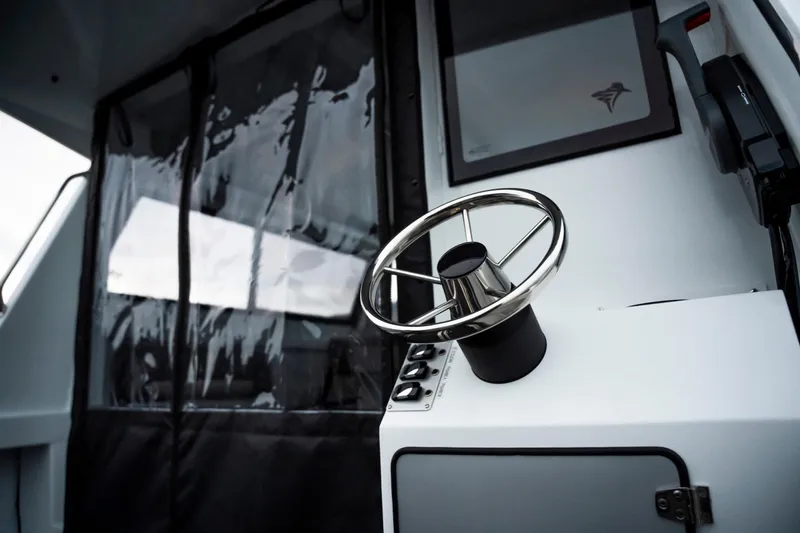 Slide: The Image of Steering wheel of 2026 KingFisher 23 XAC boat, showcasing modern design and controls. - 10