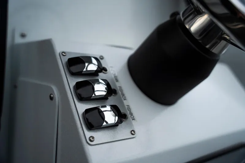 Slide: The Image of Control panel of 2026 KingFisher 23 XAC boat with switches and steering wheel. - 11