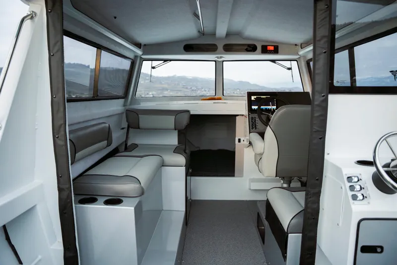 Slide: The Image of Interior of 2026 KingFisher 23 XAC boat, featuring modern seating and navigation controls. - 3