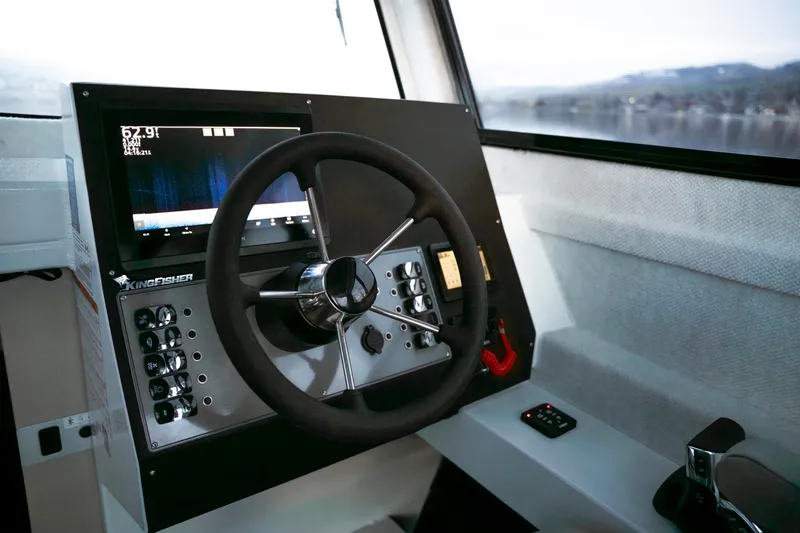 Slide: The Image of Helm of 2026 KingFisher 23 XAC boat with steering wheel and control panel. - 5