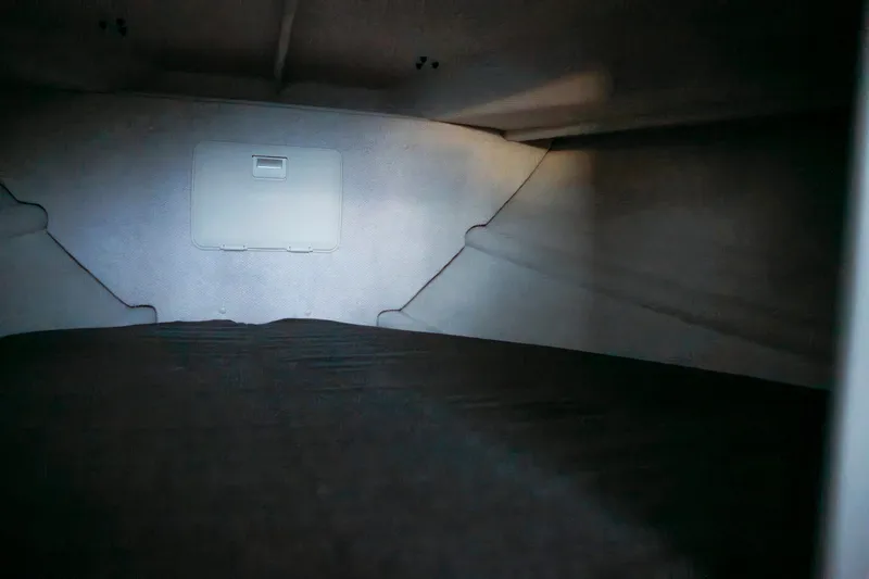 Slide: The Image of Interior cabin view of 2026 KingFisher 23 XAC boat, featuring a compact sleeping area. - 9