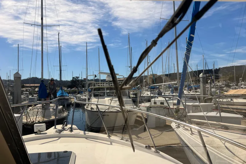 Slide: The Image of 2005 Shamrock 270 Mackinaw in a busy marina, surrounded by sailboats under a blue sky. - 10