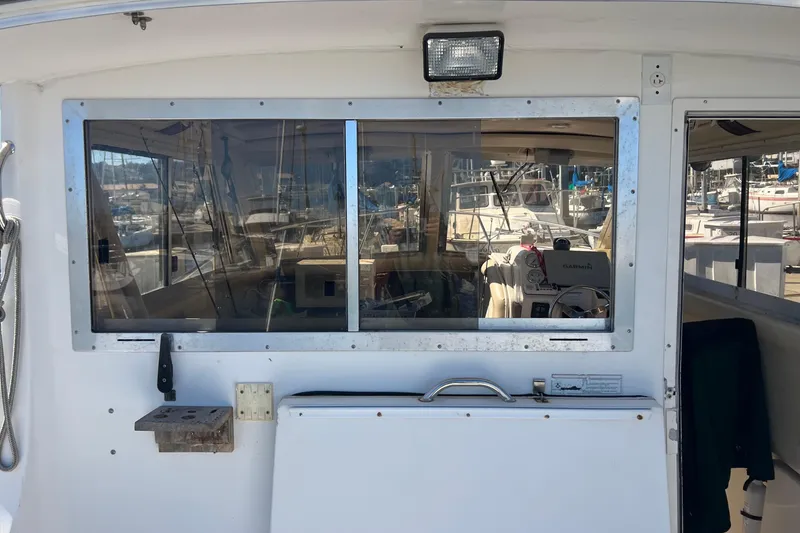 Slide: The Image of 2005 Shamrock 270 Mackinaw boat interior view with marina background. - 11