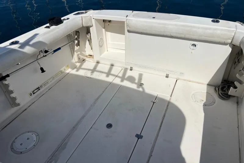 Slide: The Image of 2005 Shamrock 270 Mackinaw boat deck with storage compartments and fishing rod holders. - 12