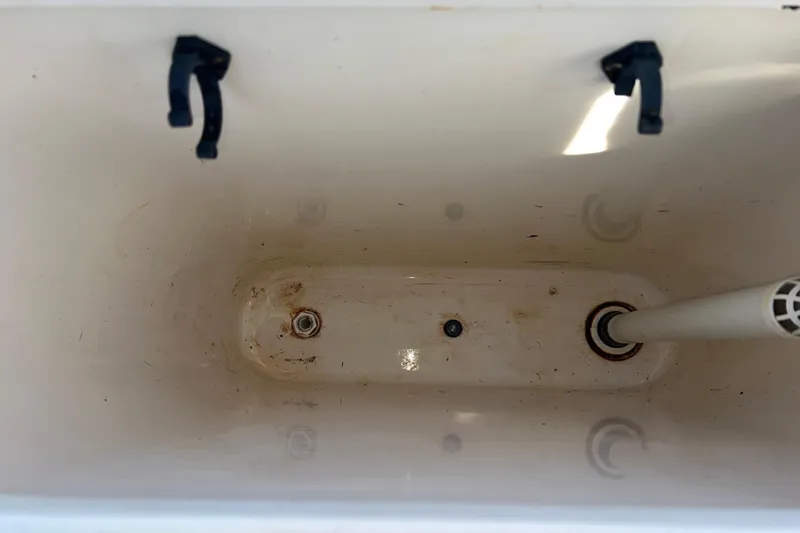 Slide: The Image of Empty storage compartment in 2005 Shamrock 270 Mackinaw boat, showing drain and latches. - 14