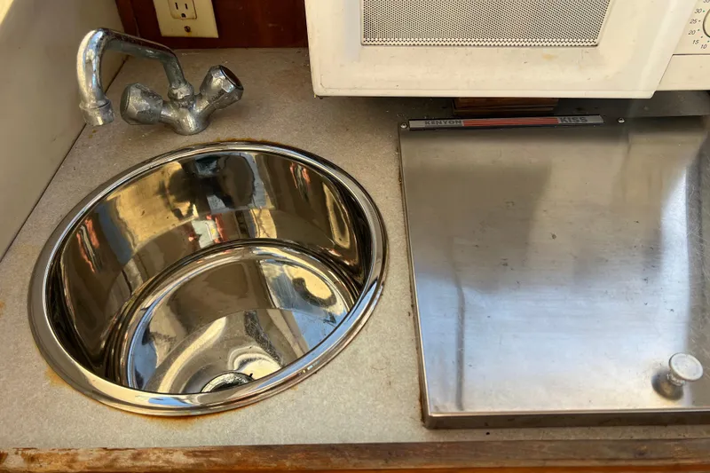 Slide: The Image of Stainless steel sink and stove in 2005 Shamrock 270 Mackinaw boat kitchen. - 16