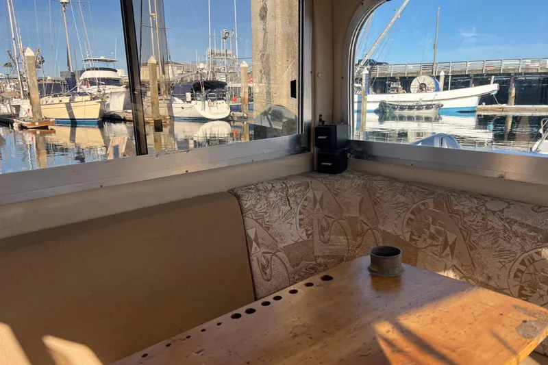 Slide: The Image of Interior view of 2005 Shamrock 270 Mackinaw boat with marina backdrop. - 17