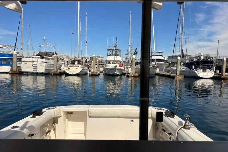 Slide: The Image of View from a 2005 Shamrock 270 Mackinaw boat in a marina with docked vessels. - 2