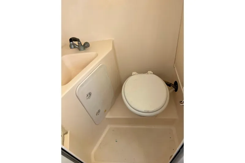 Slide: The Image of Compact bathroom in 2005 Shamrock 270 Mackinaw boat with toilet and sink. - 21