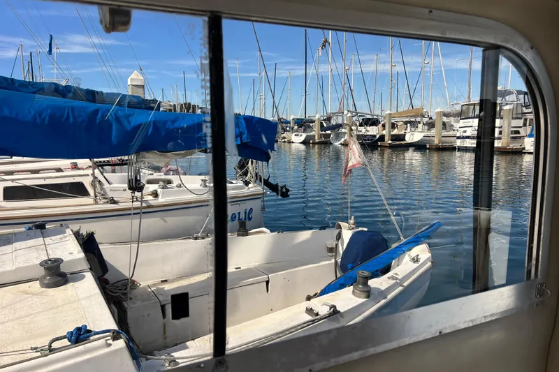 Slide: The Image of Marina view from 2005 Shamrock 270 Mackinaw, showcasing docked sailboats and clear blue sky. - 3
