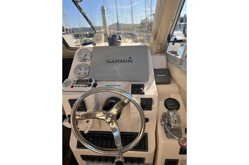 Slide: The Image of Helm of 2005 Shamrock 270 Mackinaw with Garmin navigation system and steering wheel. - 6