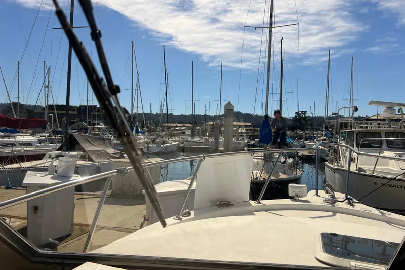 Slide: The Image of 2005 Shamrock 270 Mackinaw in a marina with sailboats and clear sky. - 8