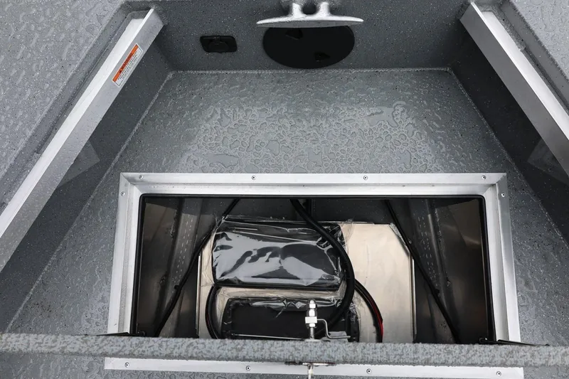 Slide: The Image of Interior view of 2026 Thunder Jet 229 Rush OT boat compartment with wiring and storage. - 12