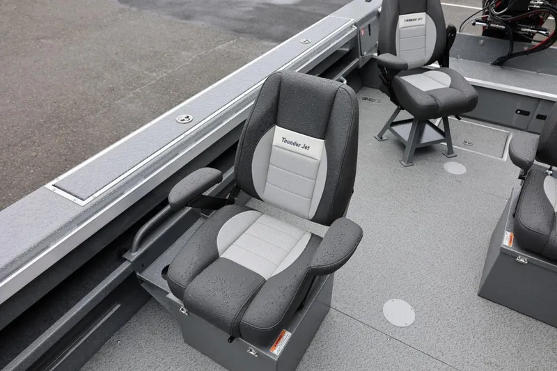 Slide: The Image of 2026 Thunder Jet 229 Rush OT boat interior with gray seating and armrests. - 13