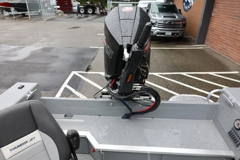 Slide: The Image of 2026 Thunder Jet 229 Rush OT boat with powerful outboard motor in a parking lot. - 16