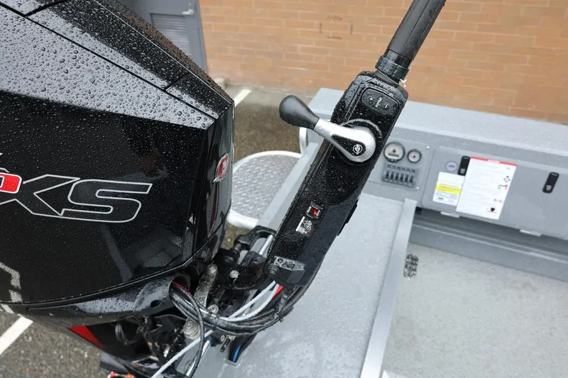 Slide: The Image of Close-up of 2026 Thunder Jet 229 Rush OT boat controls and engine in wet conditions. - 21