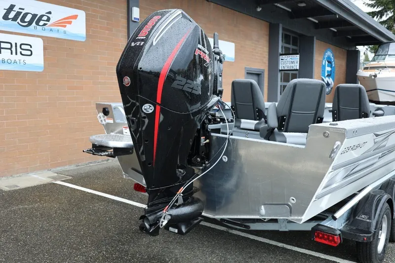 Slide: The Image of 2026 Thunder Jet 229 Rush OT boat with powerful outboard motor in a showroom setting. - 3