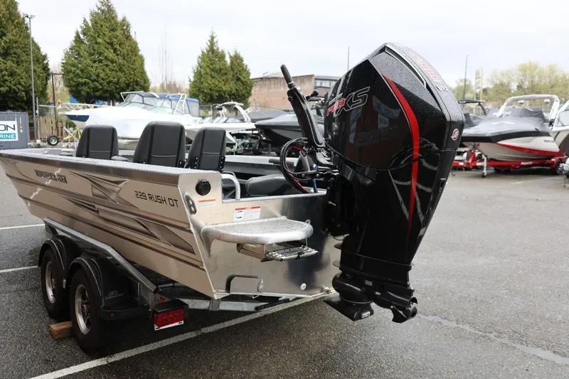 Slide: The Image of 2026 Thunder Jet 229 Rush OT boat with powerful outboard motor in a marina setting. - 5