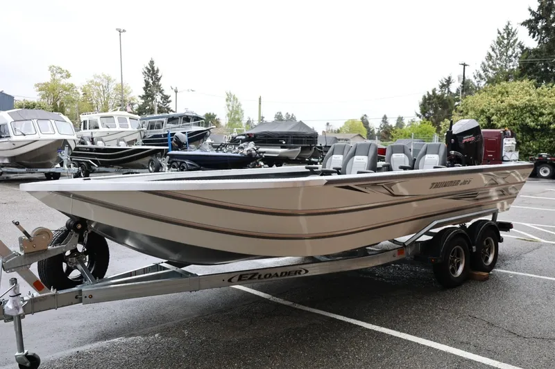 Slide: The Image of 2026 Thunder Jet 229 Rush OT boat on trailer in parking lot. - 7