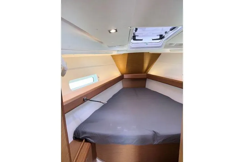 Slide: The Image of Interior cabin of 2018 Jeanneau Sun Odyssey 419 sailboat, featuring a cozy bed and skylight. - 10