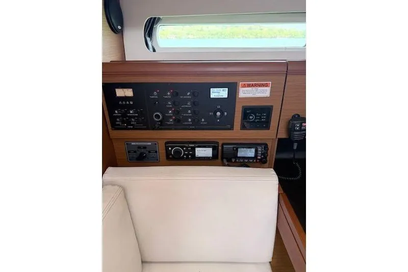 Slide: The Image of Control panel of 2018 Jeanneau Sun Odyssey 419 sailboat, featuring navigation and communication equipment. - 11