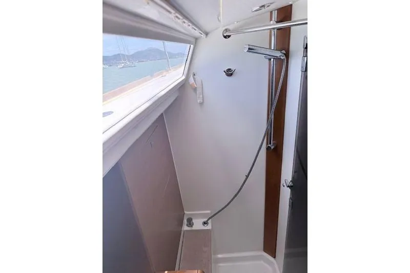 Slide: The Image of Interior shower area of 2018 Jeanneau Sun Odyssey 419 sailboat with window view. - 13