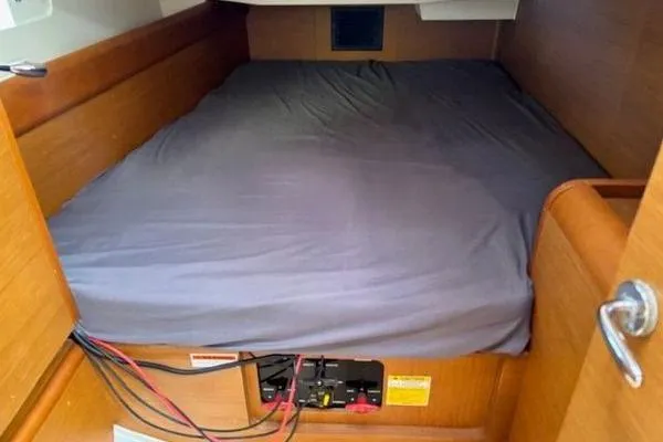 Slide: The Image of Cozy cabin bed in 2018 Jeanneau Sun Odyssey 419 sailboat, featuring wooden interior. - 15