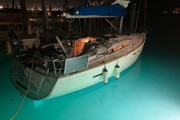 Slide: The Image of 2018 Jeanneau Sun Odyssey 419 sailboat docked at night with solar panel. - 17