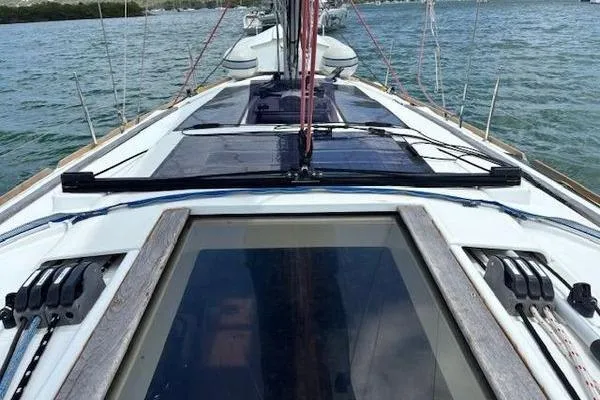 Slide: The Image of 2018 Jeanneau Sun Odyssey 419 sailboat deck with rigging, on calm waters. - 25