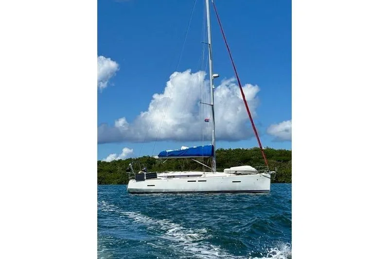 Slide: The Image of 2018 Jeanneau Sun Odyssey 419 sailboat on blue water under a clear sky. - 3