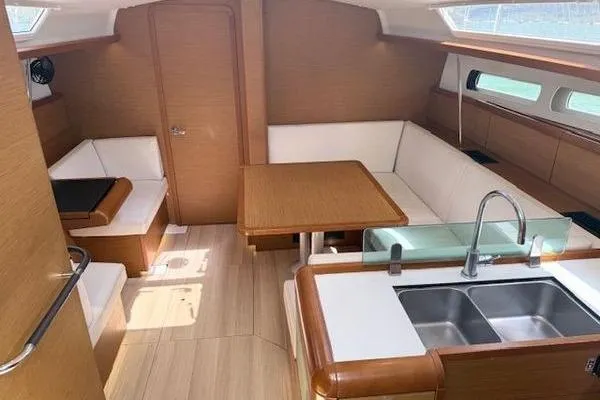 Slide: The Image of Interior of 2018 Jeanneau Sun Odyssey 419 yacht with modern kitchen and seating area. - 7