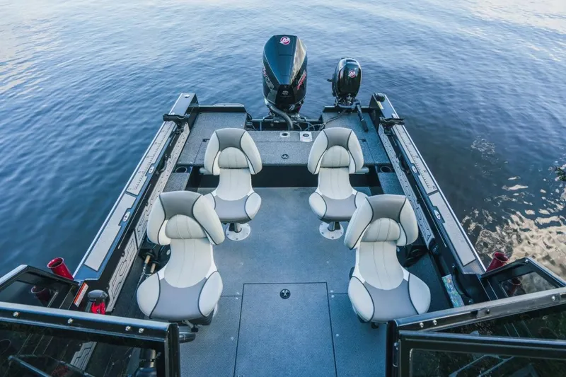 Slide: The Image of 2026 KingFisher 1925 Arrow Sport boat interior with four seats on calm water. - 6