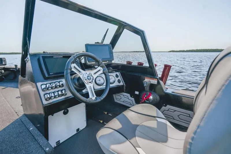Slide: The Image of Interior of 2026 KingFisher 1925 Arrow Sport boat with modern dashboard and steering. - 9