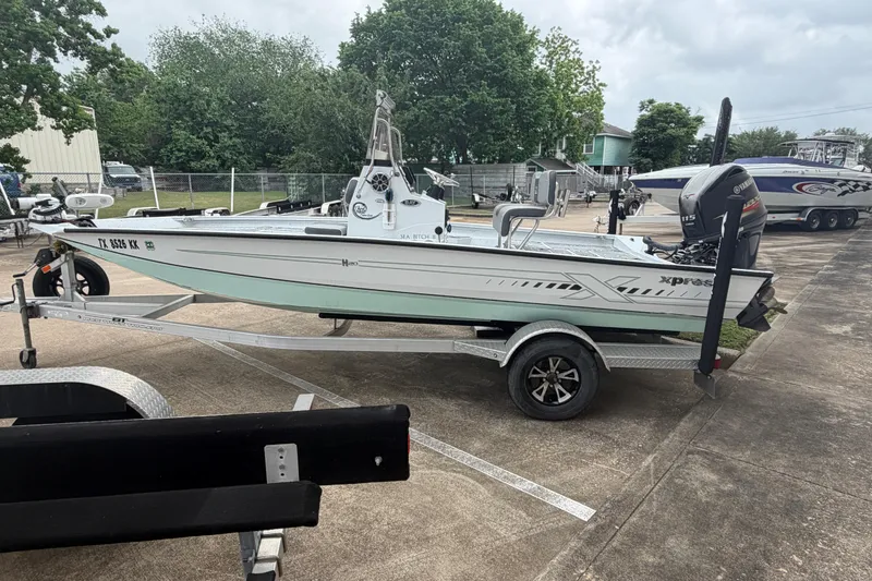 The Image of 2022 Xpress H20B Bay boat on trailer, parked outdoors. - 1