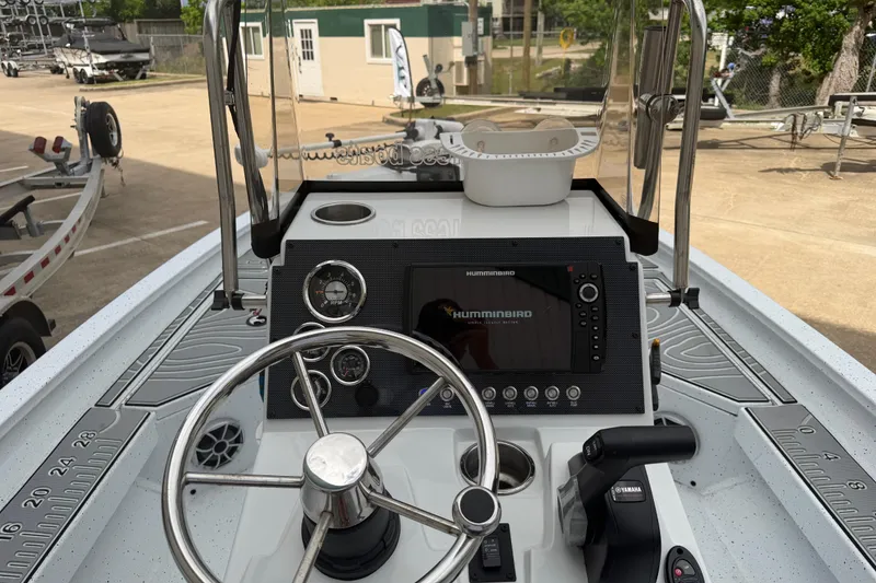 Slide: The Image of 2022 Xpress H20B Bay boat dashboard with steering wheel and Humminbird electronics. - 11