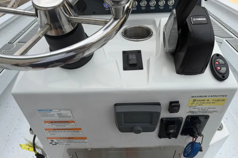 Slide: The Image of 2022 Xpress H20B Bay boat console with steering wheel and Yamaha controls. - 16