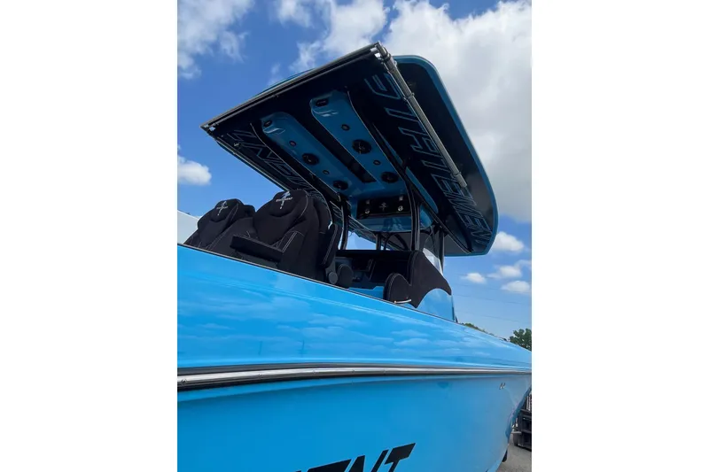 Slide: The Image of Blue 2025 Statement 350 Open boat interior with speakers and seating under a cloudy sky. - 11