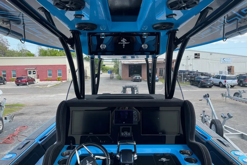 Slide: The Image of 2025 Statement 350 Open boat with illuminated engines docked at night. - 3