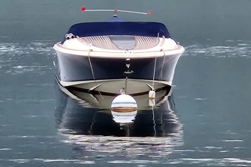 Slide: The Image of 2014 Chris Craft Corsair 34 boat on calm water, front view. - 10