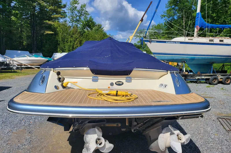 Slide: The Image of 2014 Chris Craft Corsair 34 boat with covered deck, docked outdoors. - 11