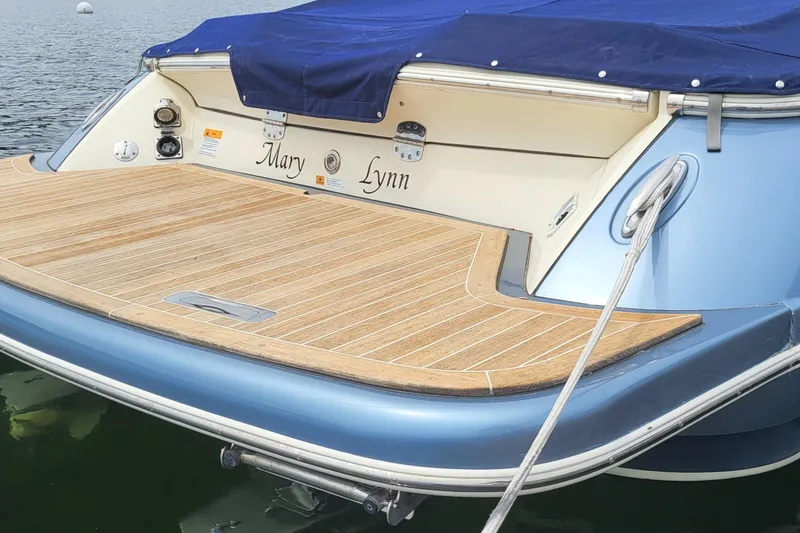 Slide: The Image of 2014 Chris Craft Corsair 34 boat with teak swim platform and blue cover. - 3
